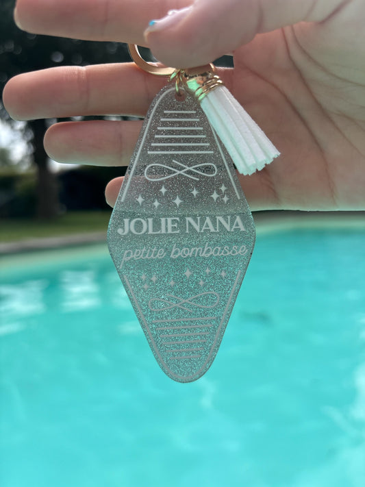 Porte-clés « Jolie nana, petite bombasse » gris pailletés